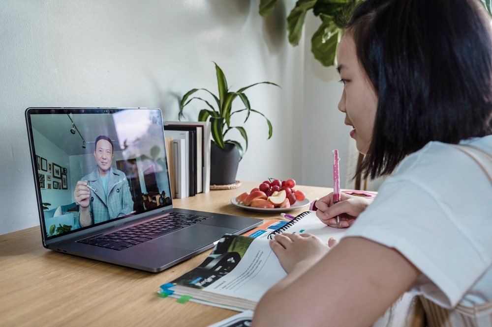 Learner attending an online class on a laptop