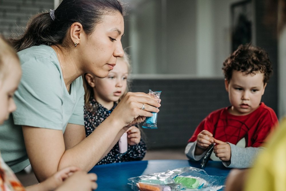 Teacher doing a craft activity with young children