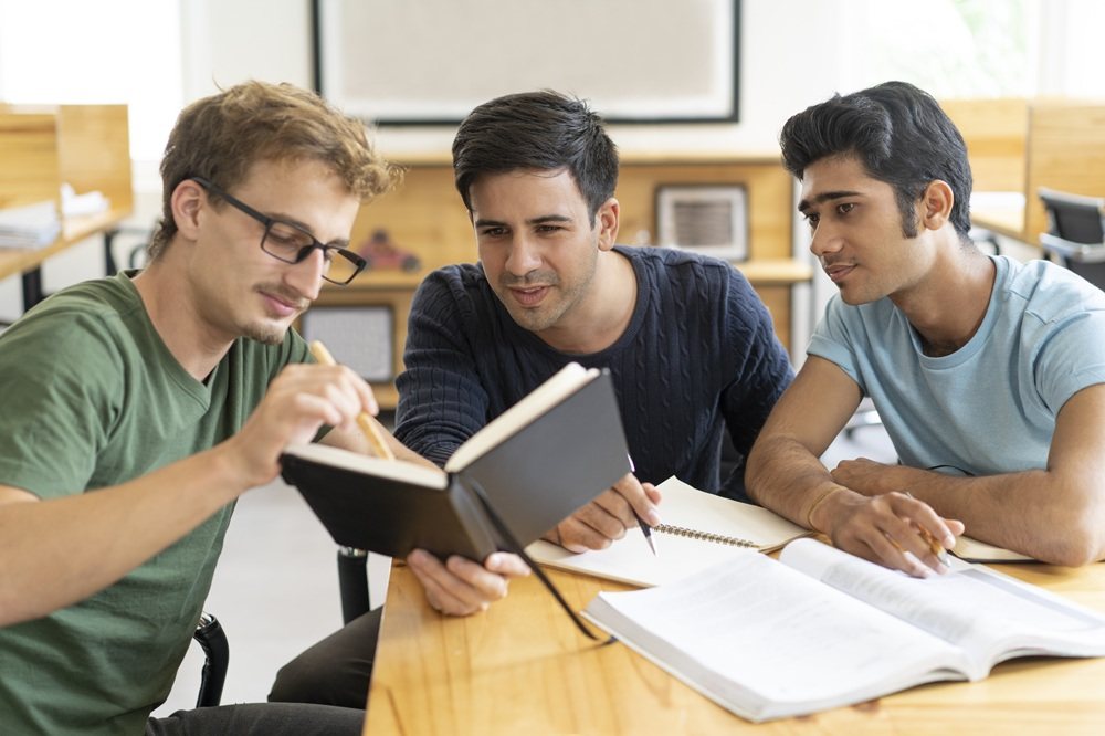 Students studying together with books